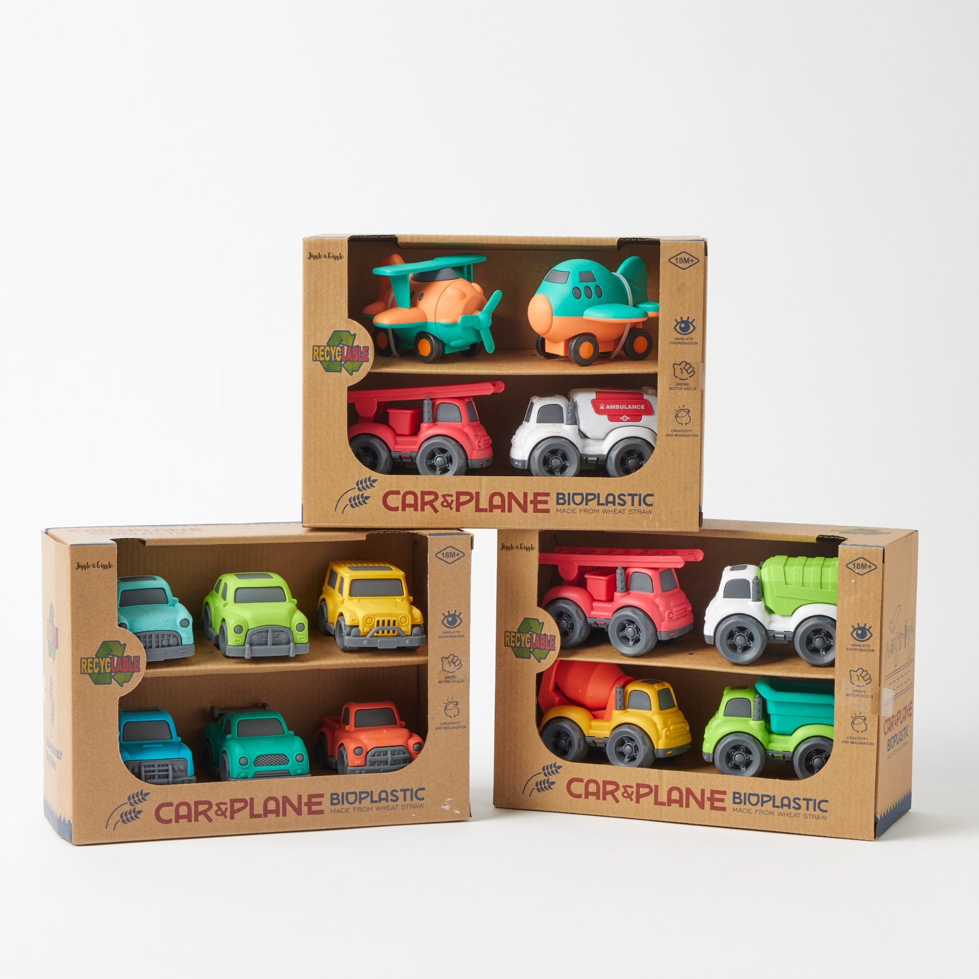 Set of bioplastic toy cars and planes in cardboard packaging on a white background