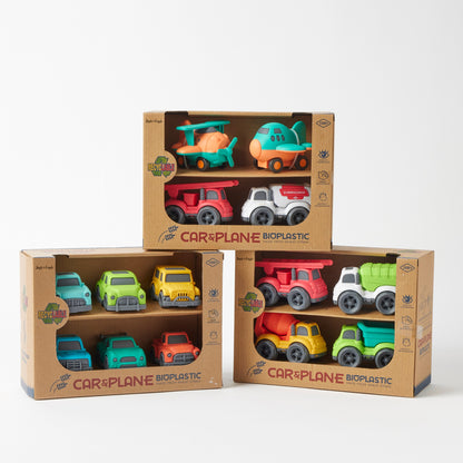 Set of bioplastic toy cars and planes in cardboard packaging on a white background