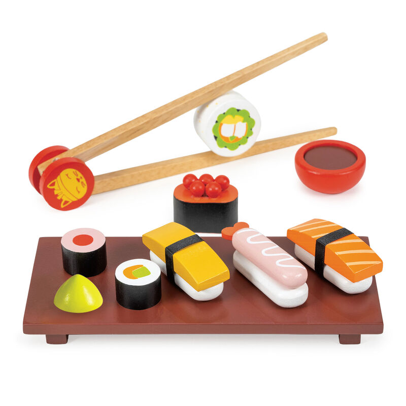 Toy sushi set with chopsticks and soy sauce on a white background
