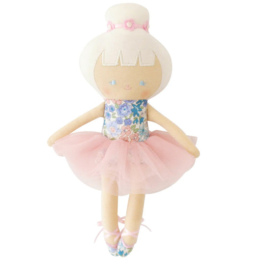 Doll in a floral dress and pink tutu on a white background