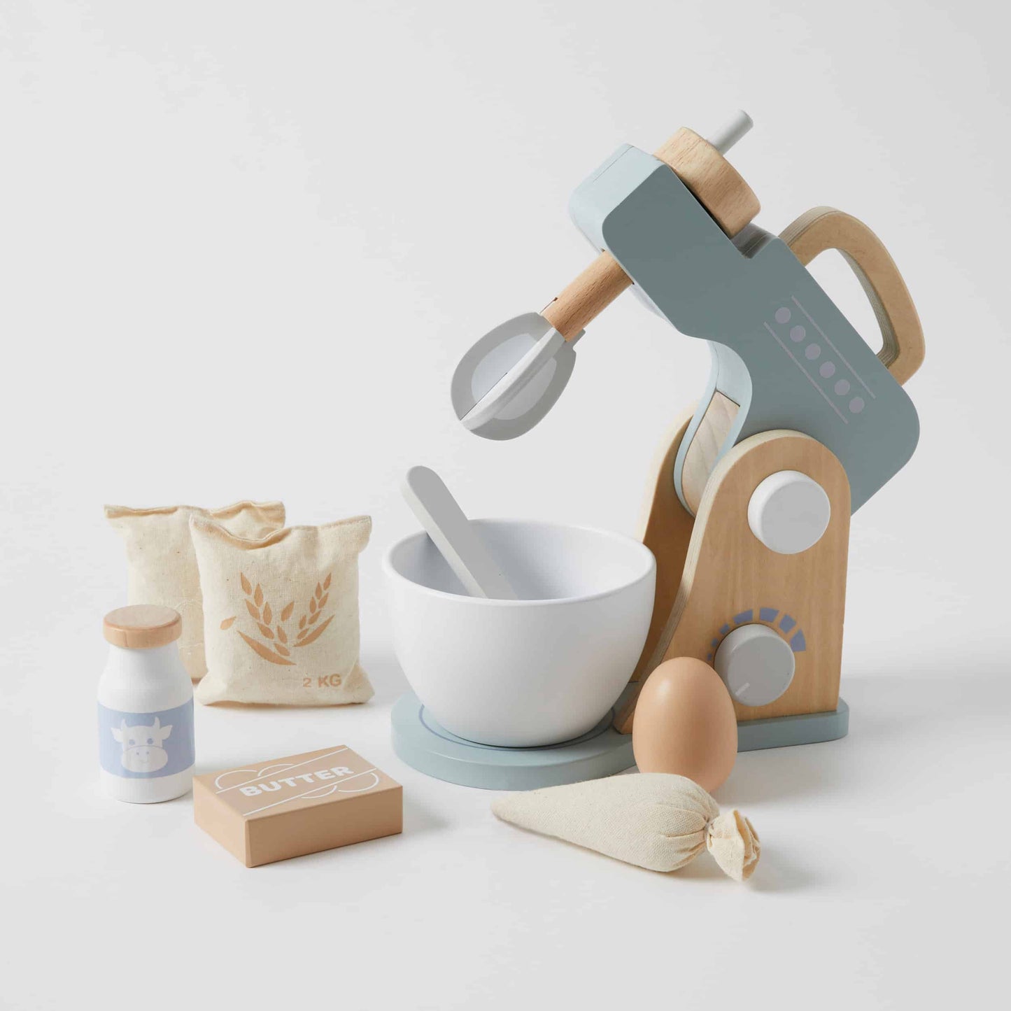 Toy kitchen set with mixer, bowls, and ingredients on a light background