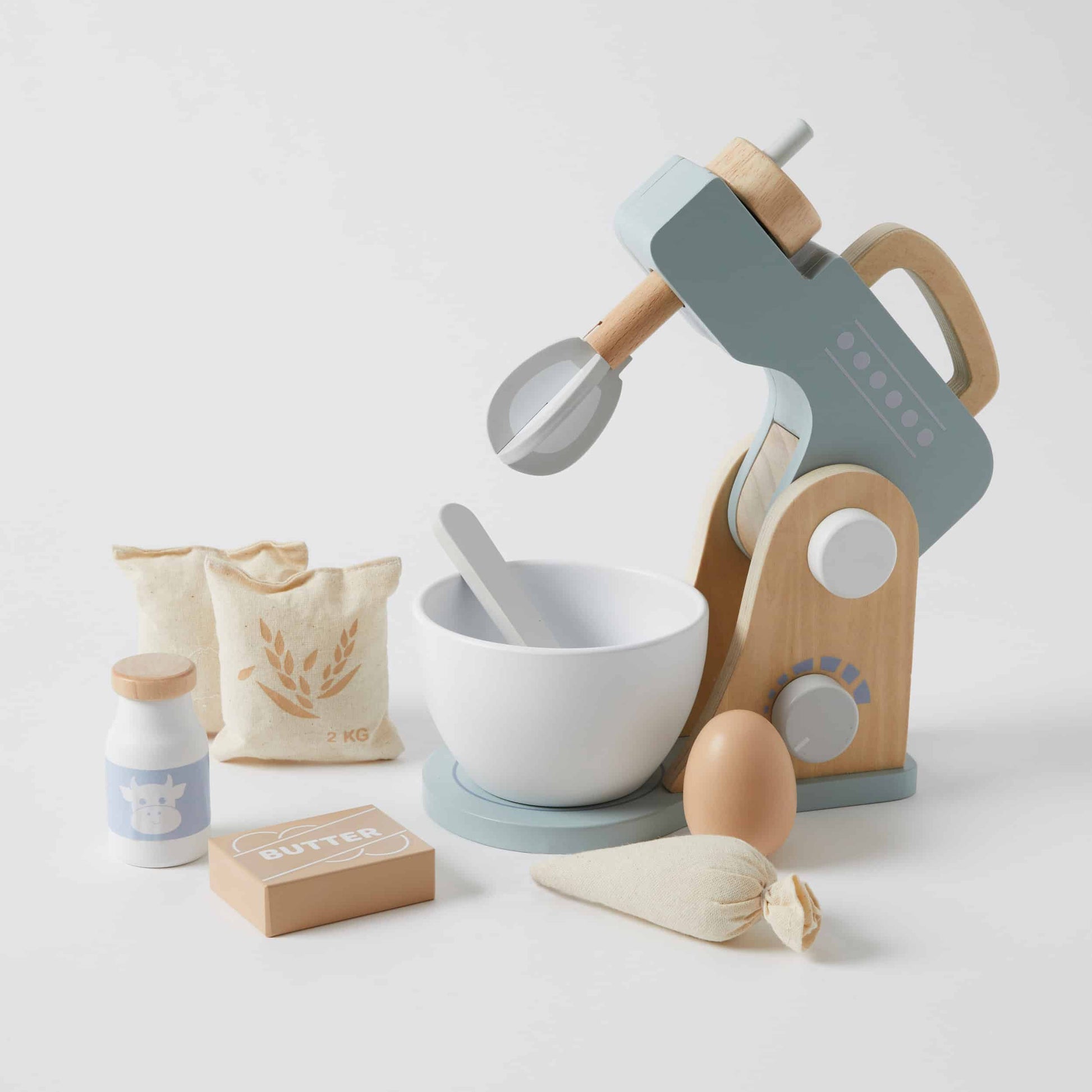 Toy kitchen set with mixer, bowls, and ingredients on a light background