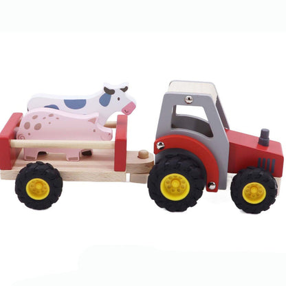 Wooden toy tractor with trailer carrying farm animals on a white background