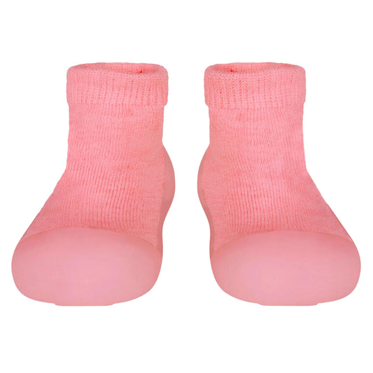 Pair of pink baby socks on a light gray background