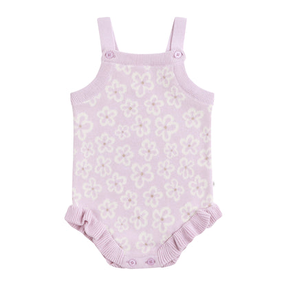 Purple floral baby romper with ruffled bottom on a white background