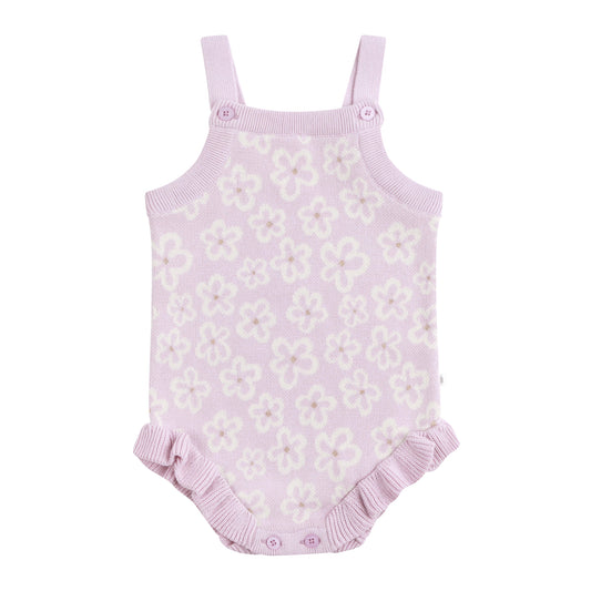 Purple floral baby romper with ruffled bottom on a white background