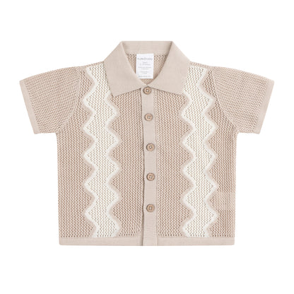 Beige knitted cardigan with white zigzag pattern on a white background