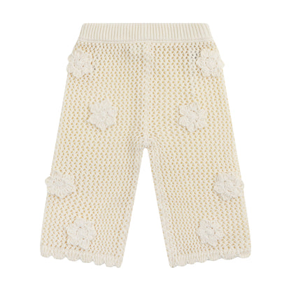 Knitted pants with floral patterns on a white background