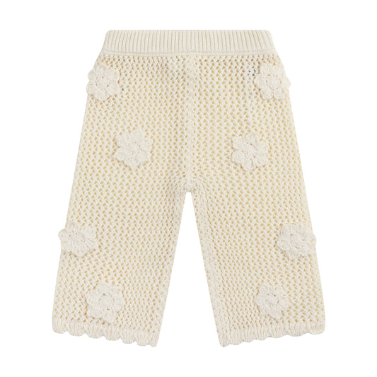 Knitted pants with floral patterns on a white background