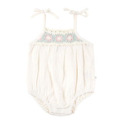 Baby romper with floral embroidery on a white background