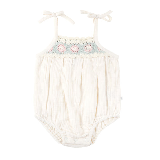 Baby romper with floral embroidery on a white background