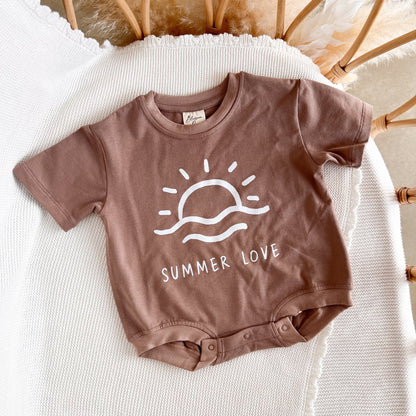 Brown baby onesie with 'Summer Love' design on a white surface