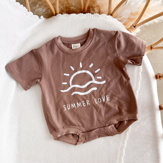 Brown baby onesie with 'Summer Love' design on a white surface