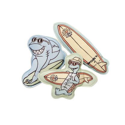 Two stickers of a shark and a lizard on surfboards with sunglasses on a white background.