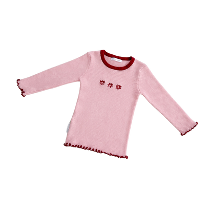 Pink long-sleeve shirt with red trim and floral patterns on a white background