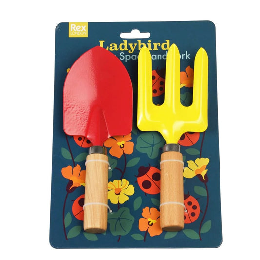 Colorful toy spade and fork set on a Ladybird branded packaging with floral and insect design.