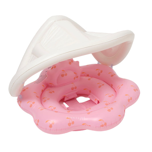 Pink inflatable baby seat with floral pattern on a white background