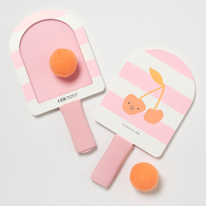 Two pink children's ping pong paddles with orange balls on a light gray background