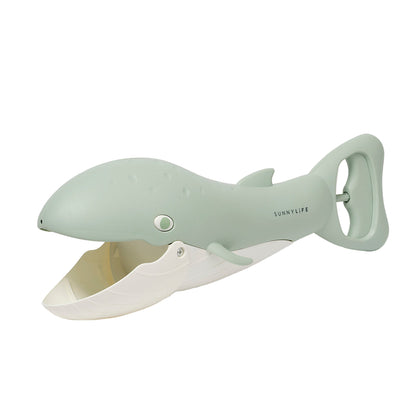 Sleek shark-shaped bottle opener on a light gray background