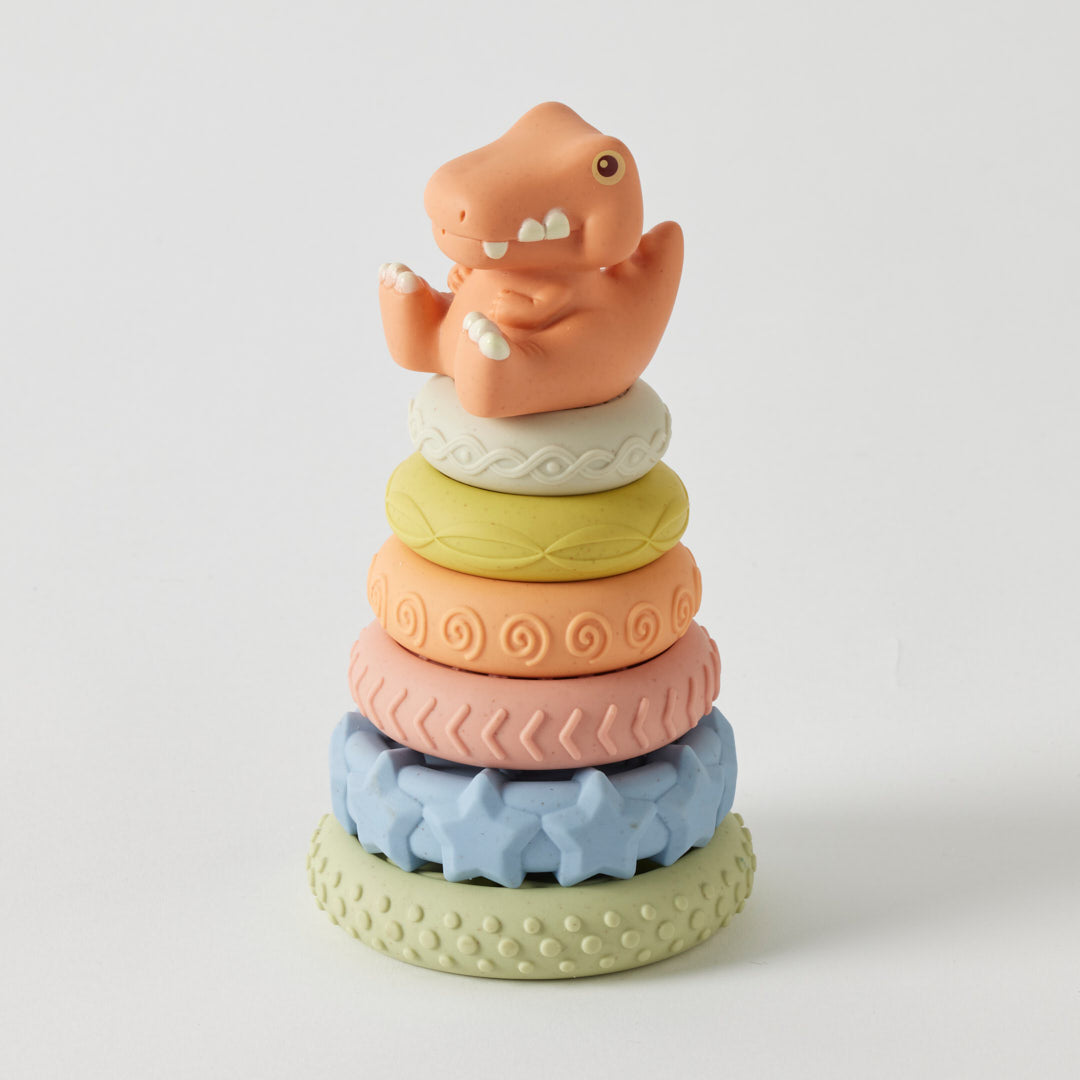 Stack of colorful dinosaur-shaped rings on a white background
