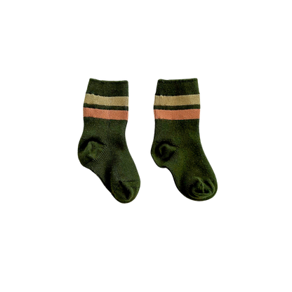 Pair of green socks with pink and beige stripes on a white background