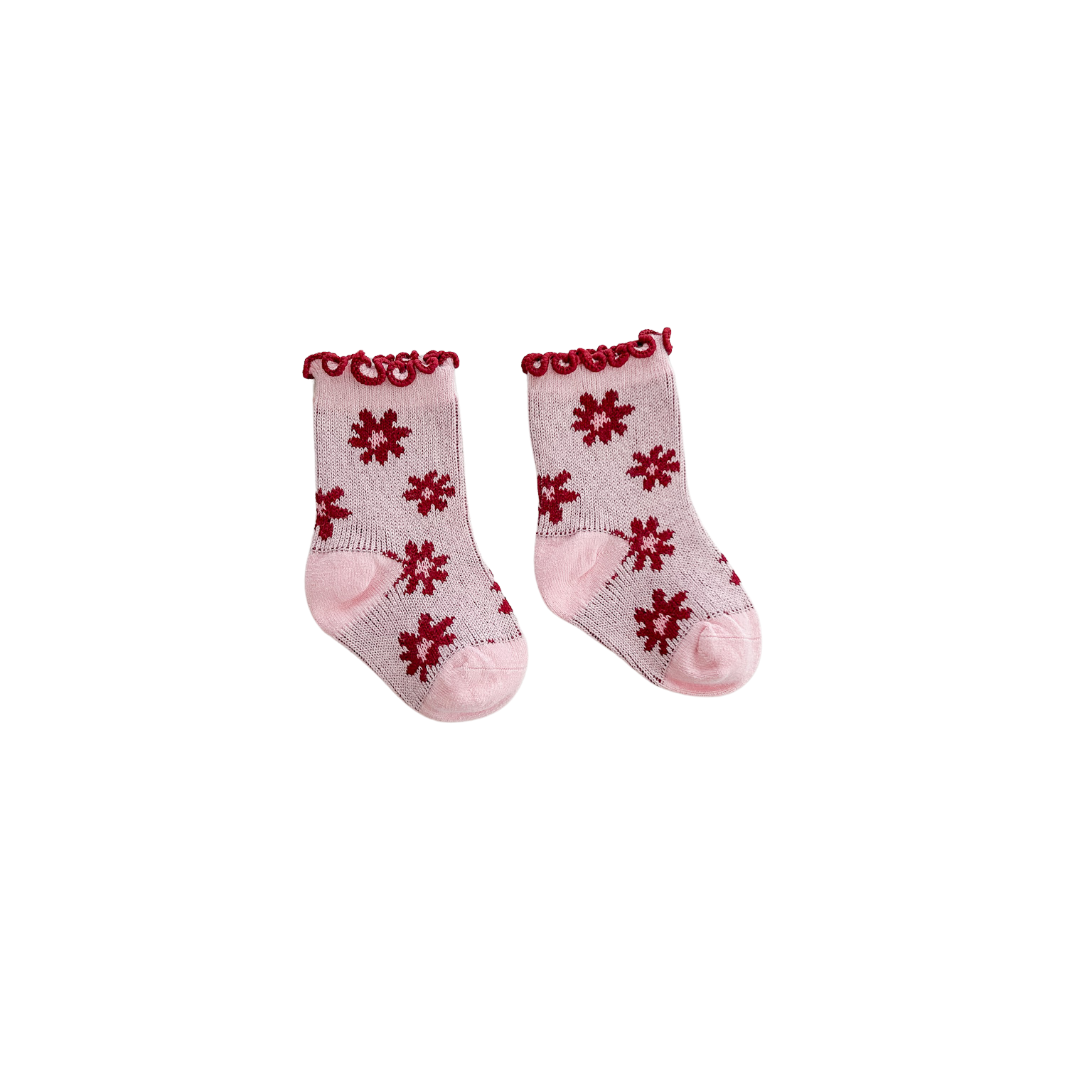Pair of pink socks with red floral patterns on a white background