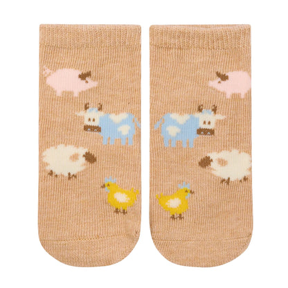 Pair of socks with farm animal pattern on a beige background