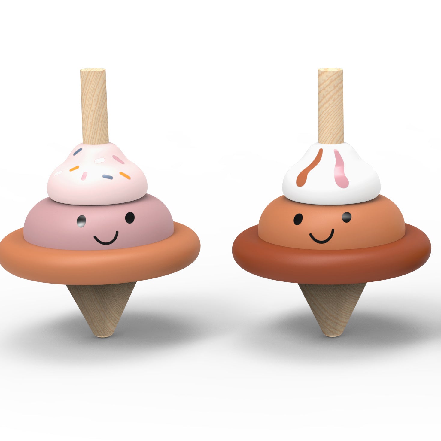 Two wooden toy ice cream cones with smiling faces, shown side by side on a clean white background. One has pink and peach layers with colorful sprinkles, and the other has peach and white layers with pink drizzle.