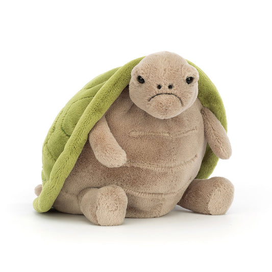 Stuffed turtle toy with a green shell on a white background
