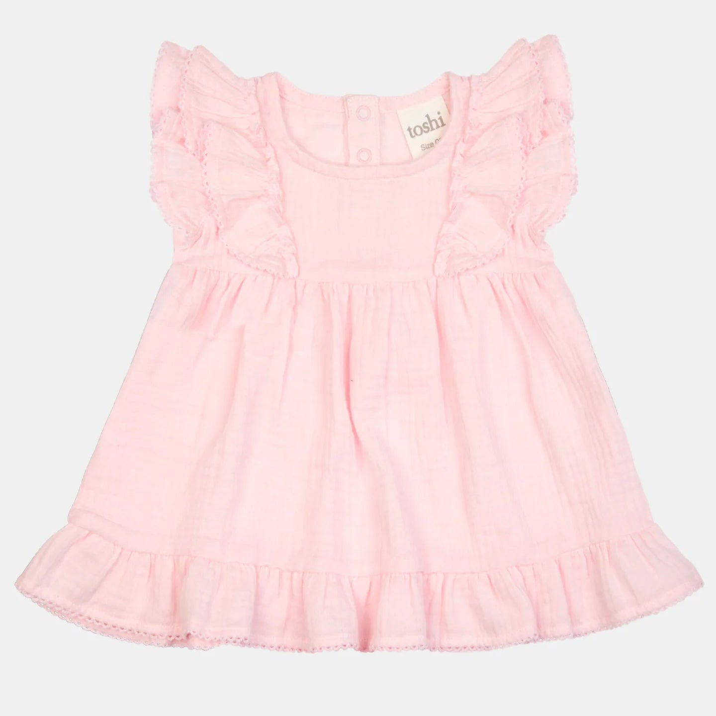 Pink dress with ruffled sleeves on a light gray background