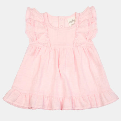 Pink dress with ruffled sleeves on a light gray background