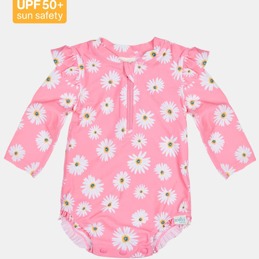 Pink children's swimsuit with daisy pattern and UPF 50+ label on a white background