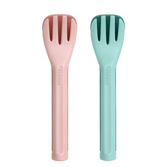 Two colorful kitchen utensils, one pink and one green, on a white background.