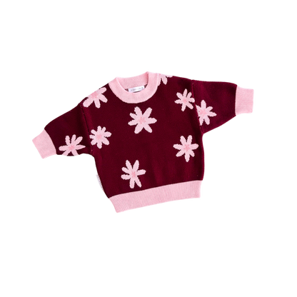 Maroon sweater with pink flower patterns on a white background