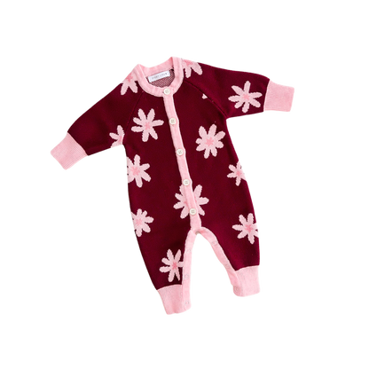 Maroon baby onesie with pink flower patterns on a white background