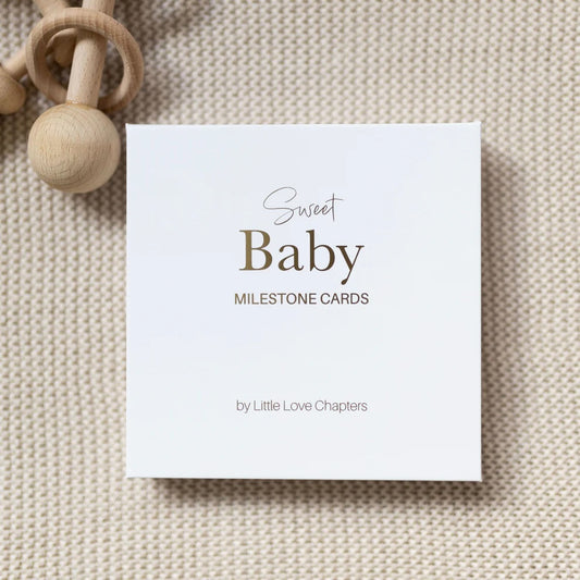 Card for Sweet Baby Milestone Cards by Little Love Chapters on a textured beige background with a wooden baby toy.