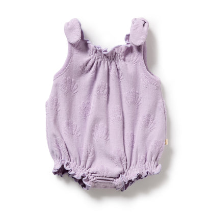 Purple baby romper with bear ears on a white background