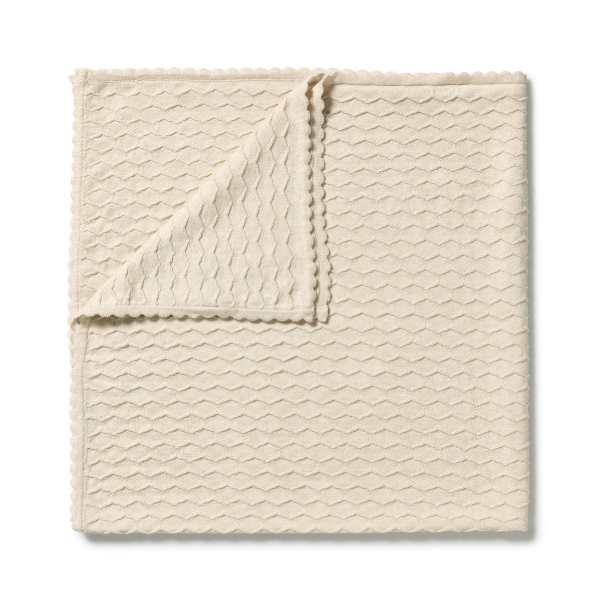 A folded cream-colored textured cloth with a wavy pattern and scalloped edges, displayed on a clean white background.