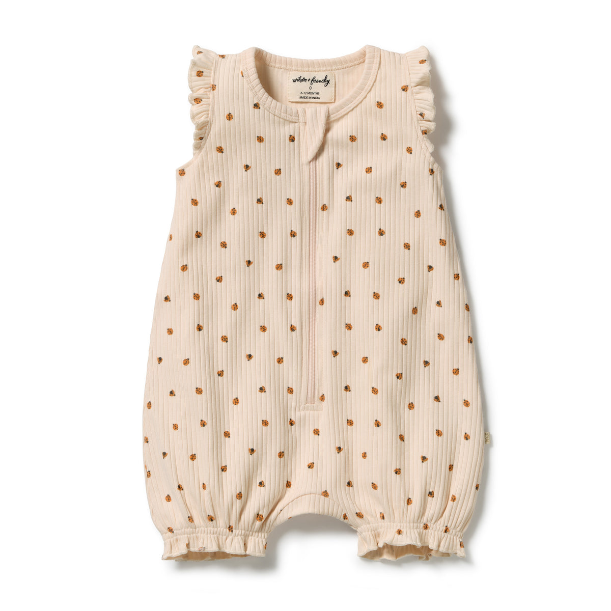 A baby sleeveless romper in cream-colored ribbed fabric with a small brown polka dot pattern, featuring ruffled shoulders and leg cuffs, laid flat on a white background.