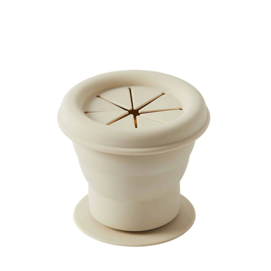 Beige ceramic pot with lid on a white background