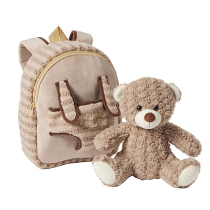 Children's backpack and teddy bear on a light gray background