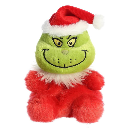 Plush toy resembling the Grinch with a red Santa hat on a white background