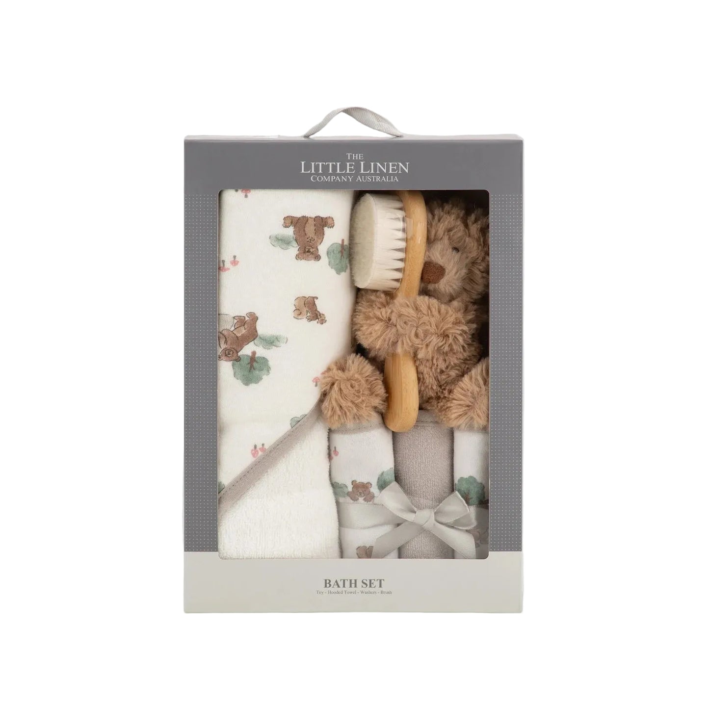 Baby bath set with towel, brush, and washcloth in a Little Linen packaging on a light gray background