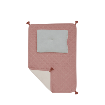 Pink quilted blanket with a gray square in the center on a white background