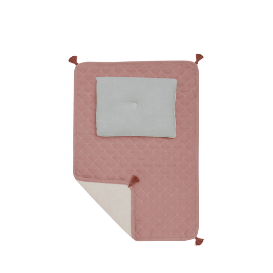 Pink quilted blanket with a gray square in the center on a white background