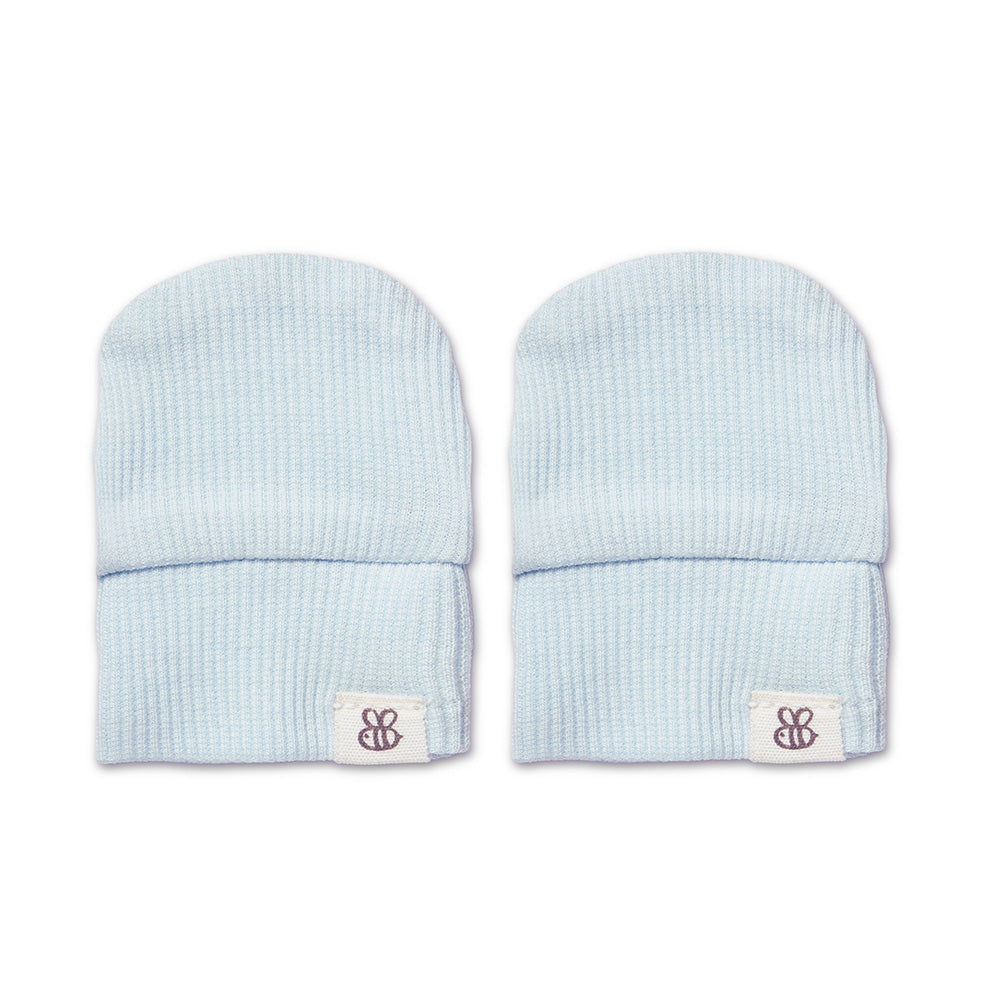 A pair of light blue ribbed knit baby beanie hats with a small white brand patch on the cuff, displayed side-by-side on a white background.