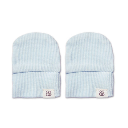 A pair of light blue ribbed knit baby beanie hats with a small white brand patch on the cuff, displayed side-by-side on a white background.