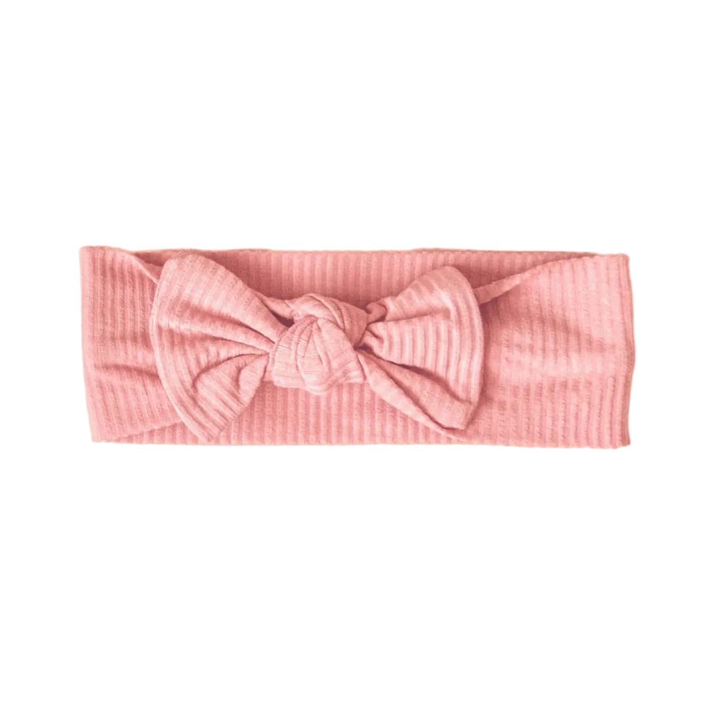 Pink ribbed headband with a bow on a beige background