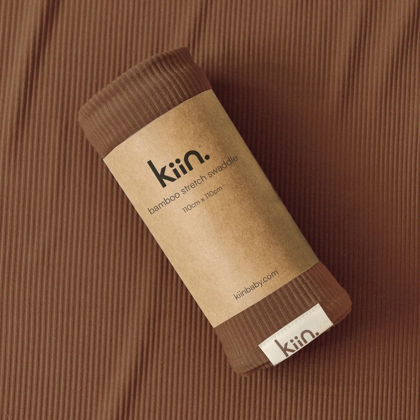 Brown fabric swatch with 'kin' label on a matching brown background