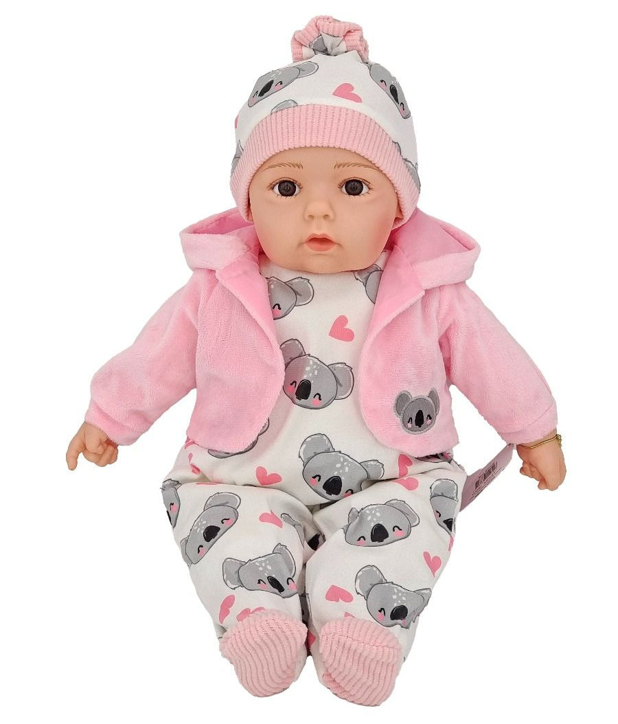 Baby doll wearing a pink outfit with koala patterns on a white background
